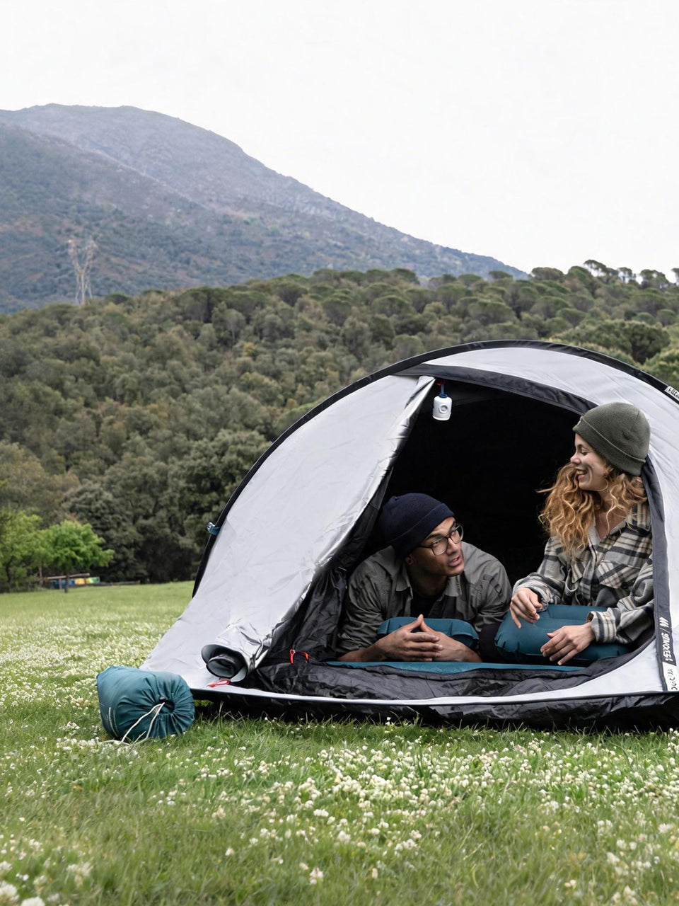 Outdoor campsite beside a forest lake